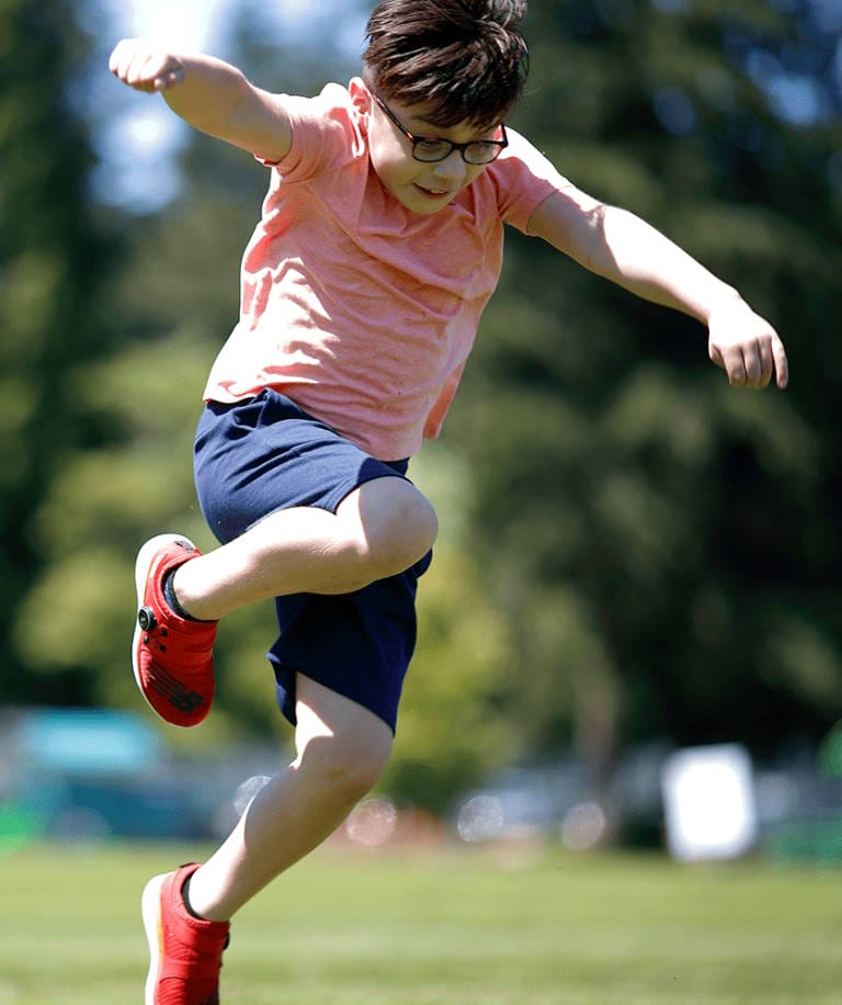 jumping-boy student learning physical activity outside