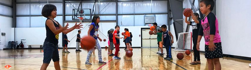 Kids playing basketball activity games in gym