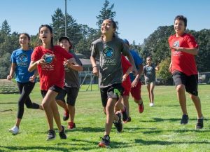 Young teens running in park